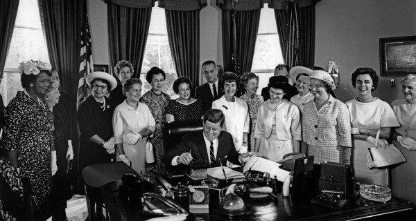 American Association of University Women members with President John F. Kennedy as he signs the Equal Pay Act into law